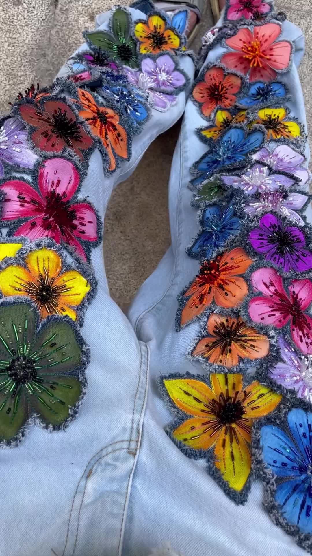 This may contain: a pair of jeans with butterflies painted on them