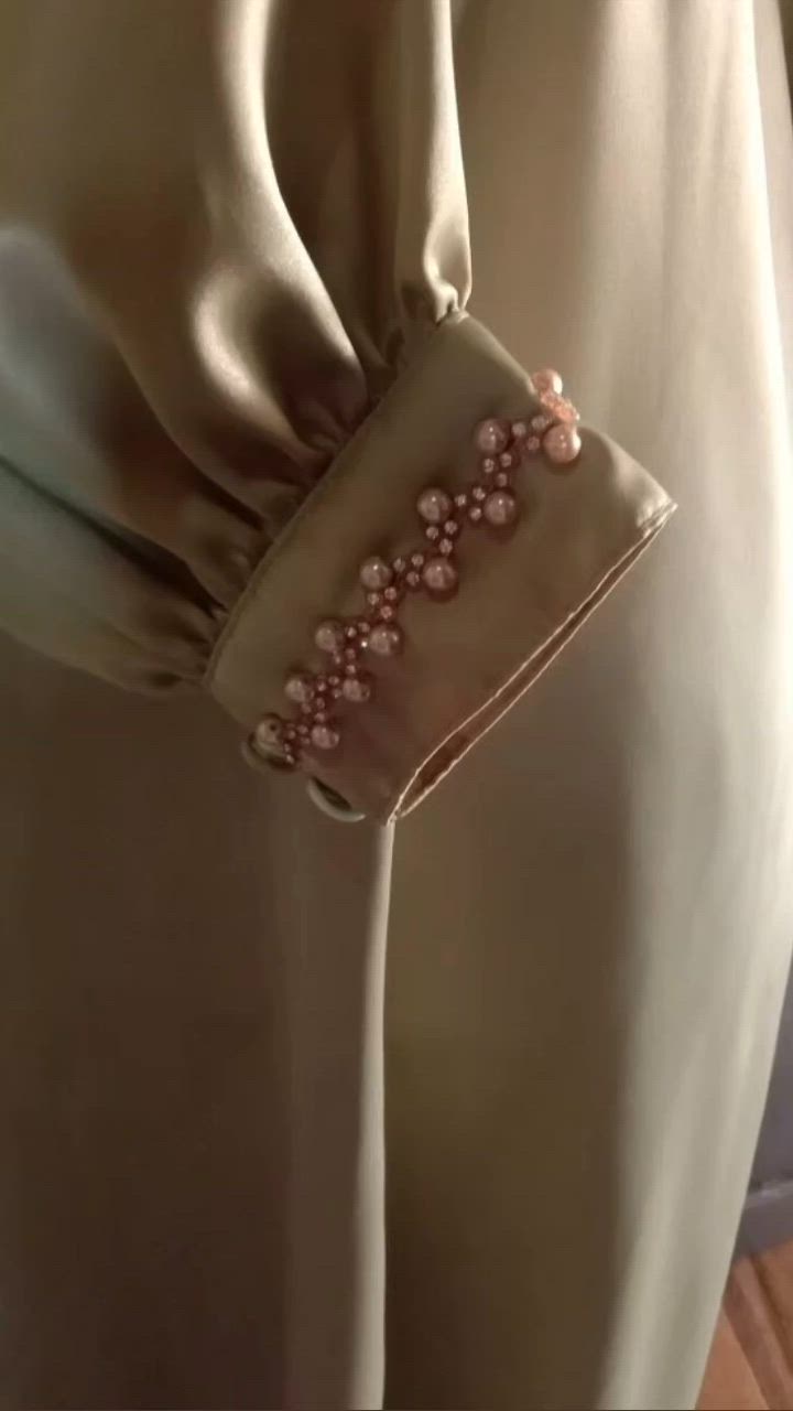 This contains an image of: Pearl detailing on sleeves