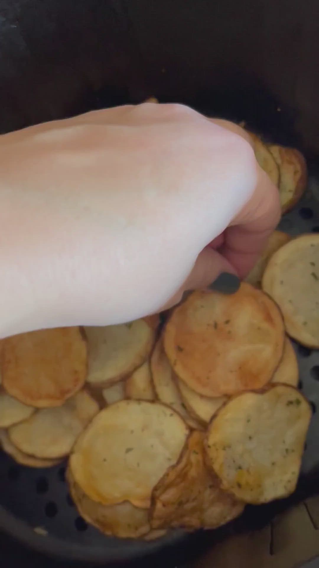 This may contain: the crispies are fried in air fryer potatoes and being held by a woman's hand