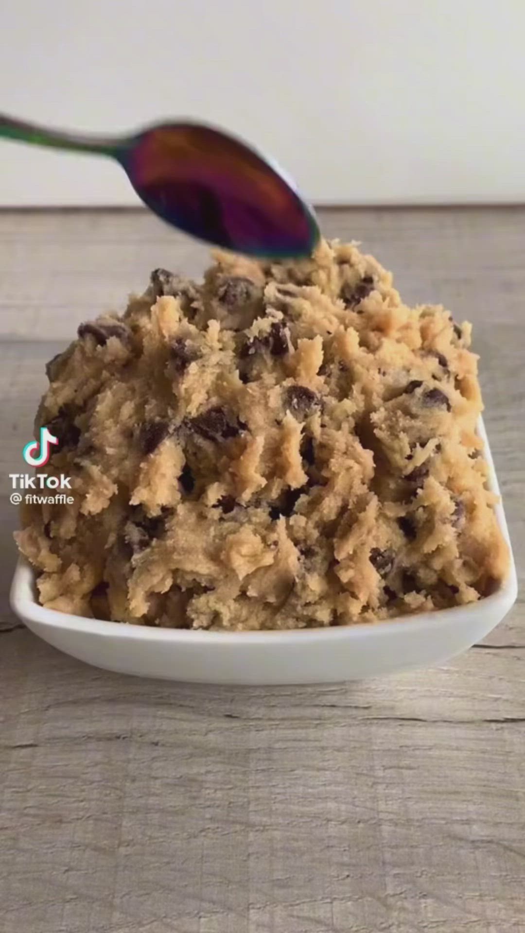 This may contain: a bowl filled with oatmeal and chocolate chips