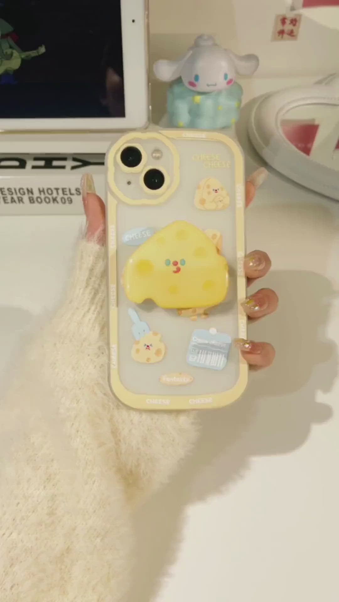 This may contain: a person holding up a cell phone case with an animal on it