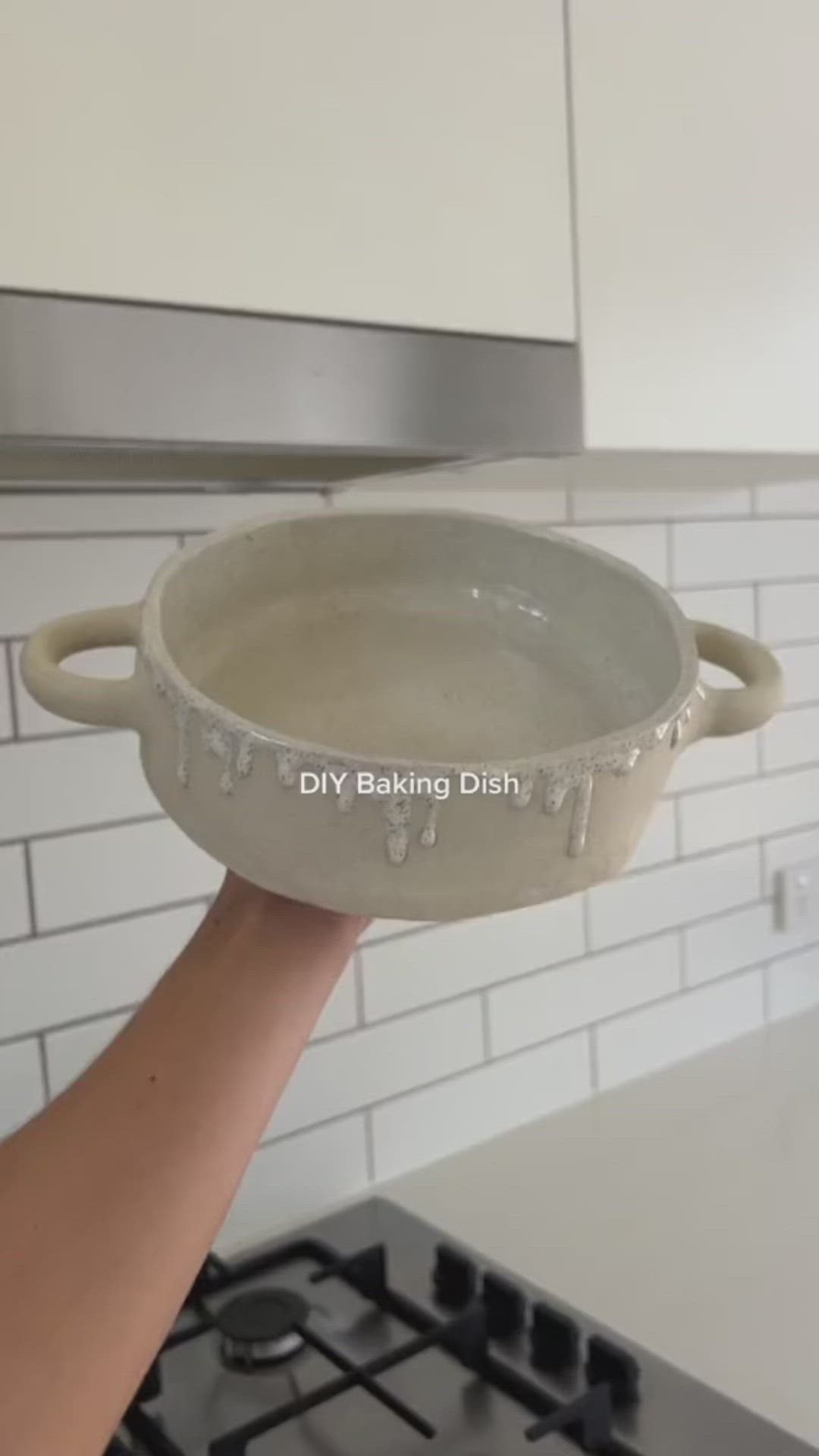 This may contain: a person holding a pan over a stove top oven with the words diy baking dish on it