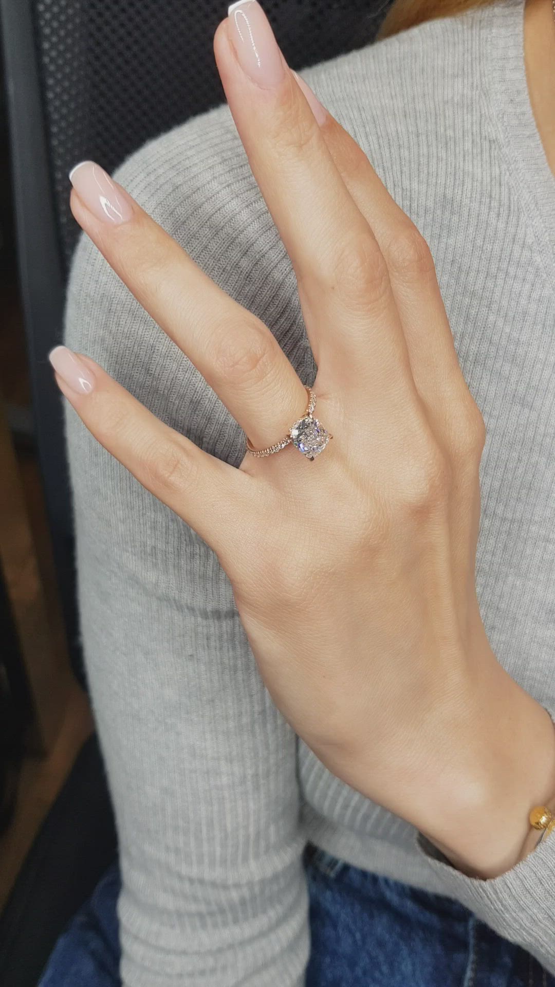 This may contain: a woman wearing a diamond ring on her finger