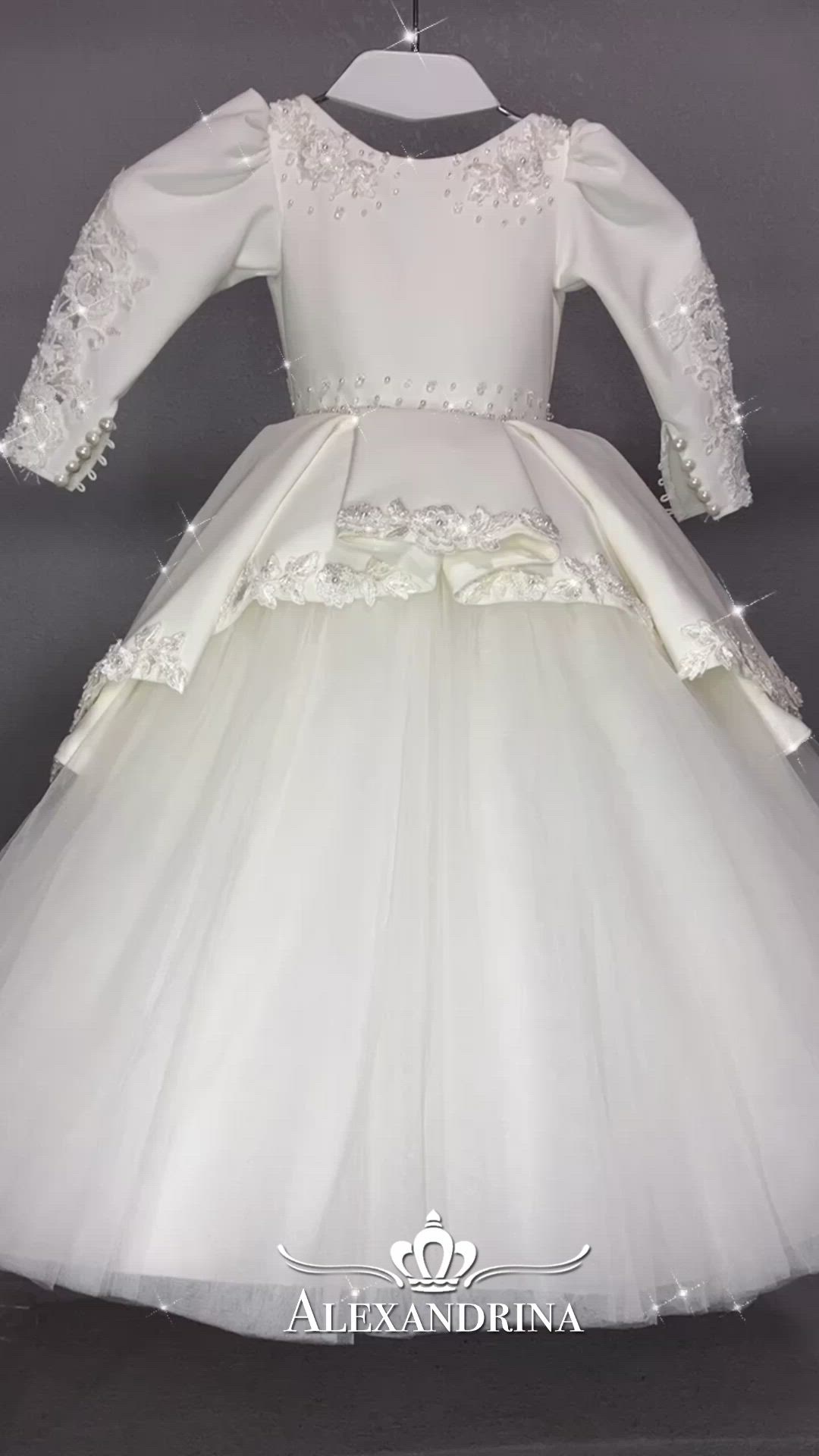 The classic dress "Yasmin" is made in white color with a small tulle train and an elegant peplum on the skirt which is decorated with lace, pearls and beads. The V-back is embroidered with floral lace. The shoulders of the dress are embroidered with lace and decorated with decorative elements. The belt is also embroidered with a scattering of stones. Sleeves with a graceful cut, closed with a stunning lace applique with beads, are especially delightful!