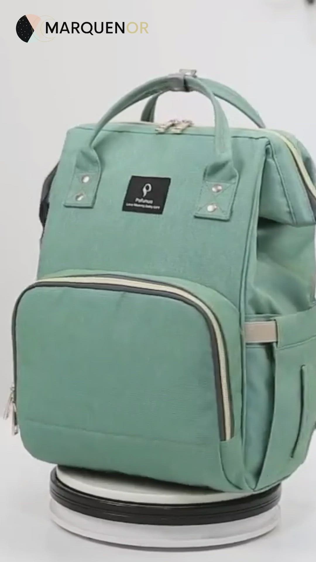 This may contain: a green backpack sitting on top of a white table