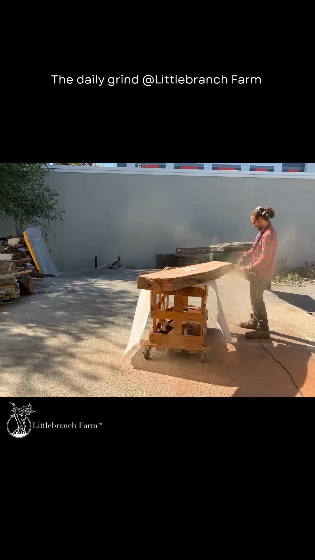 This may contain: a man standing next to a wooden table