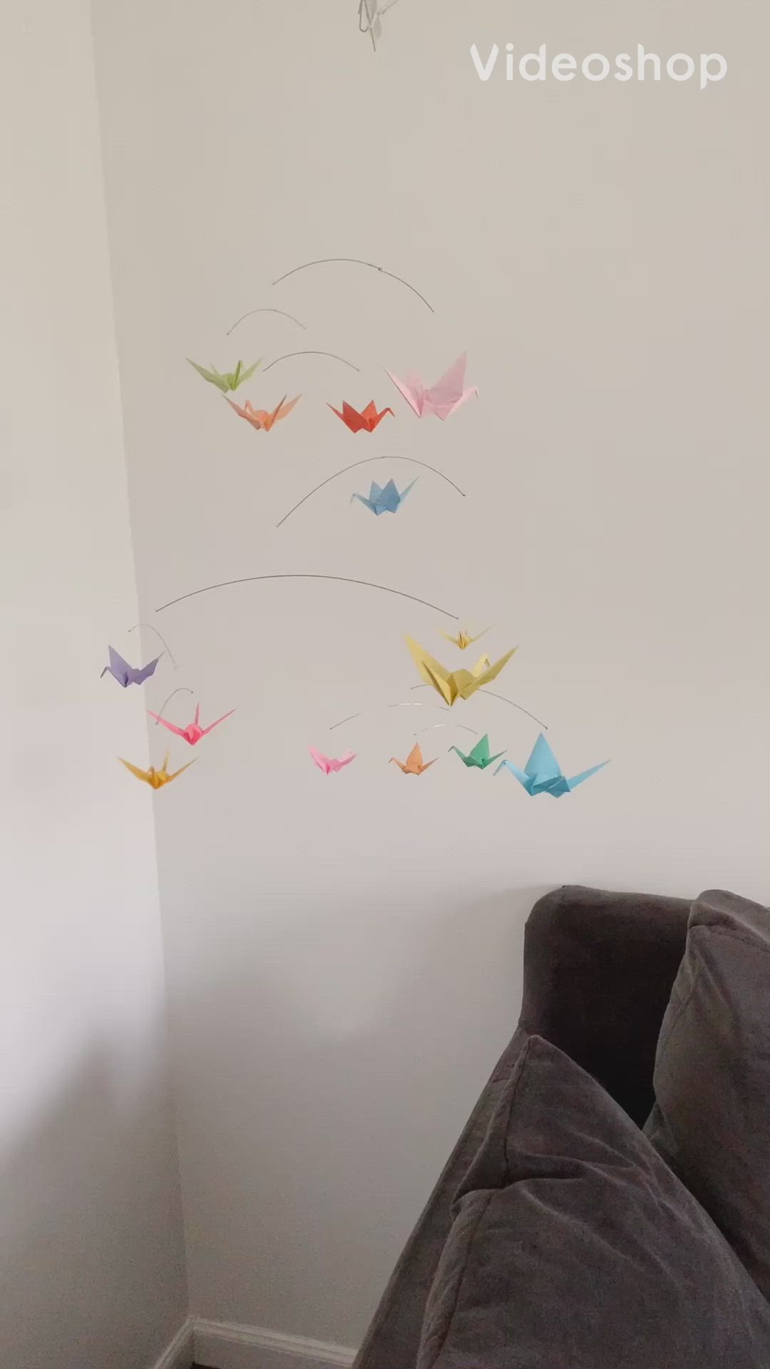 This may contain: the wall is decorated with origami birds