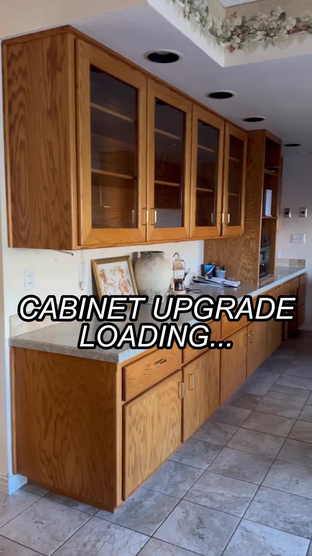 This may contain: a kitchen with cabinets and tile flooring that says cabinet upgrade loading on the bottom