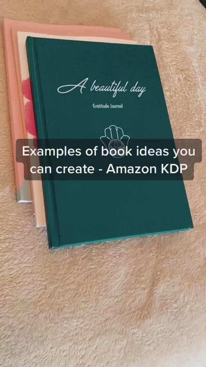 This may contain: a book sitting on top of a bed next to an orange and pink pillow with the title examples of book ideas you can create - amazon kp