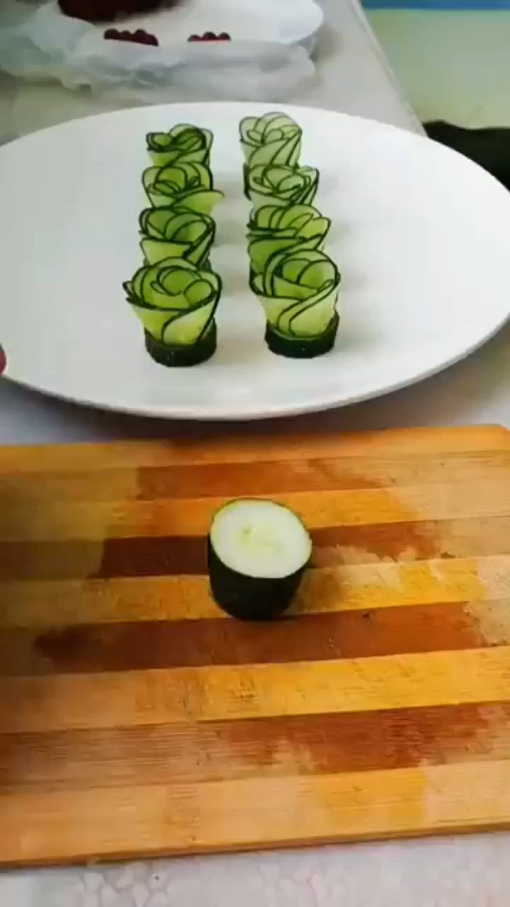 This may contain: someone cutting cucumbers on a board with a knife