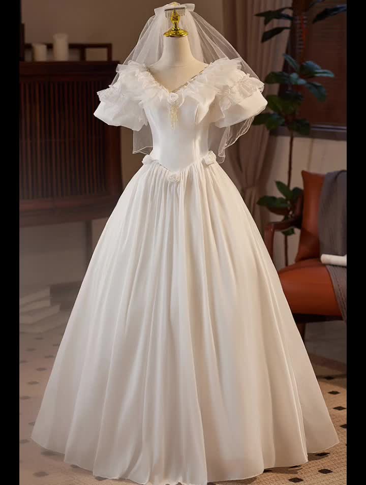 This contains: Vneck Lace Neckline Ballgown Wedding Dress with Bubble Sleeves