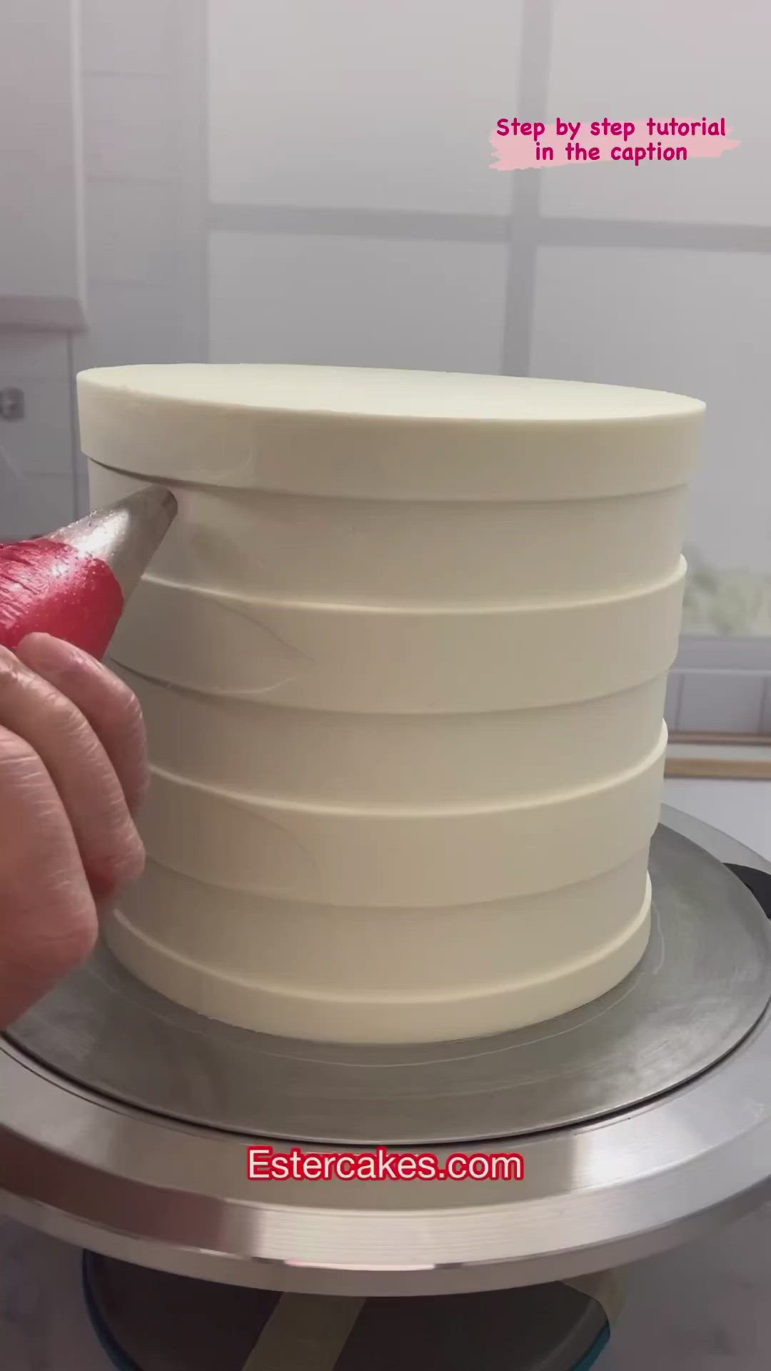 This may contain: a person in blue gloves is decorating a christmas cake with red and green frosting