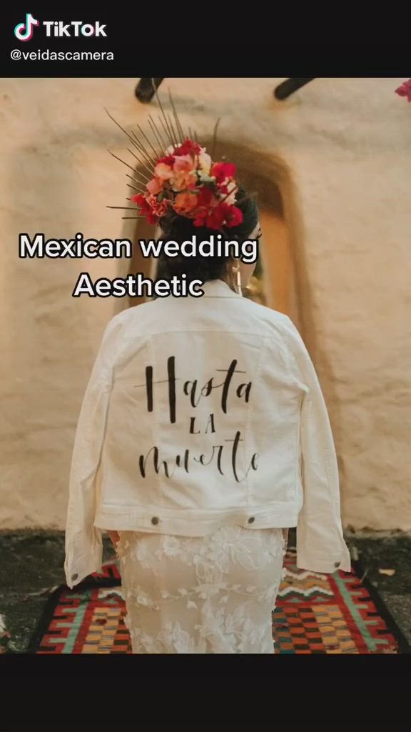 This may contain: the back of a bride's wedding jacket that says, mexican wedding aesthetic