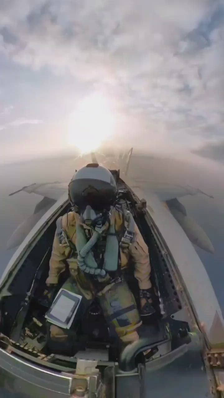 This may contain: a man sitting in the back of a boat on top of an ocean next to a jet