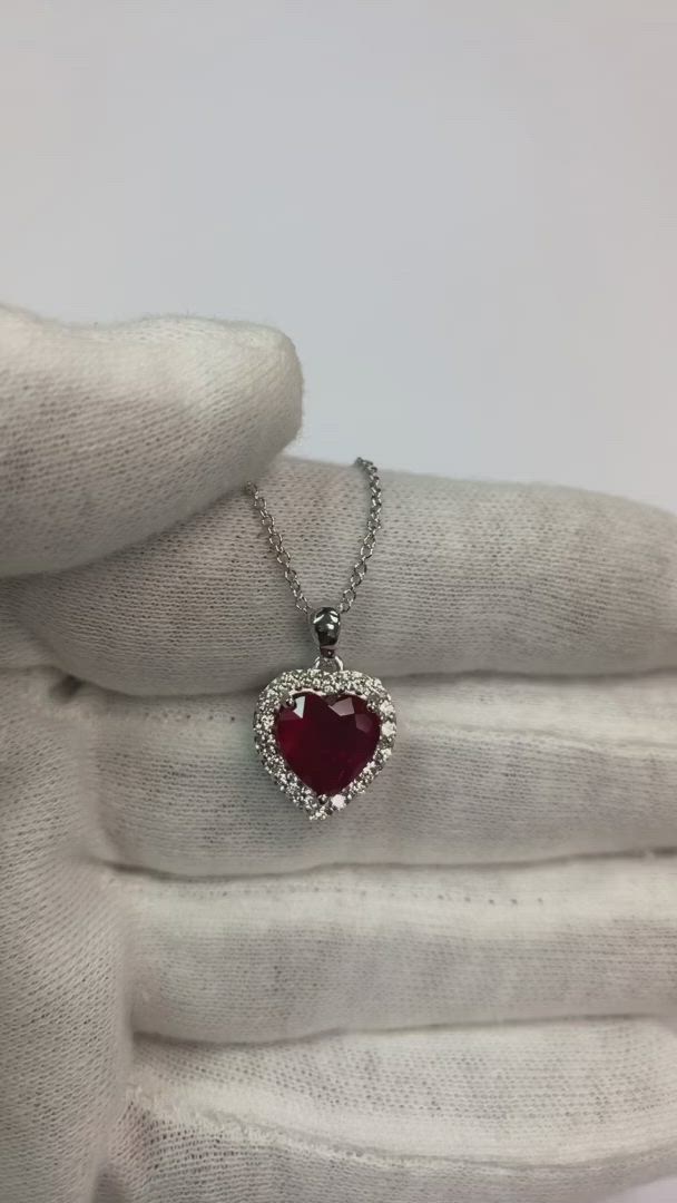 METAL SPECIFICATIONS Metal Name: White Gold 14K STONE SPECIFICATIONS Stone Name: RUBY/DIAMOND Stone Cut : Heart and Round cut Stone Specifications: There is one ruby in the center of approx. 2.50 carats (Approx. Size 7.7 x 8.9 mm) and approx. 0.20 carats round diamonds on the side. Natural earth-mined stones. Total Stone Weight : approx. 2.70 carats Color : Red/F Clarity : AAA/VVS1 PENDANT SPECIFICATIONS Appraised Value : $8288.00 Comes with Certificate Comes with 16" chain