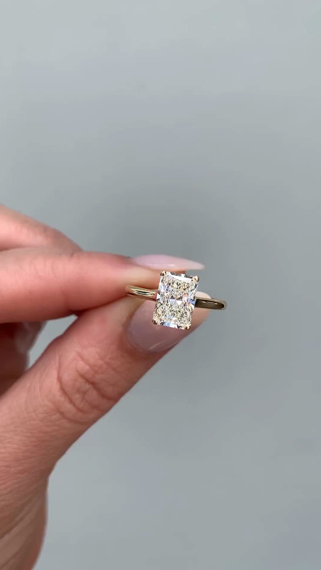 This contains: radiant cut solitaire diamond engagement ring