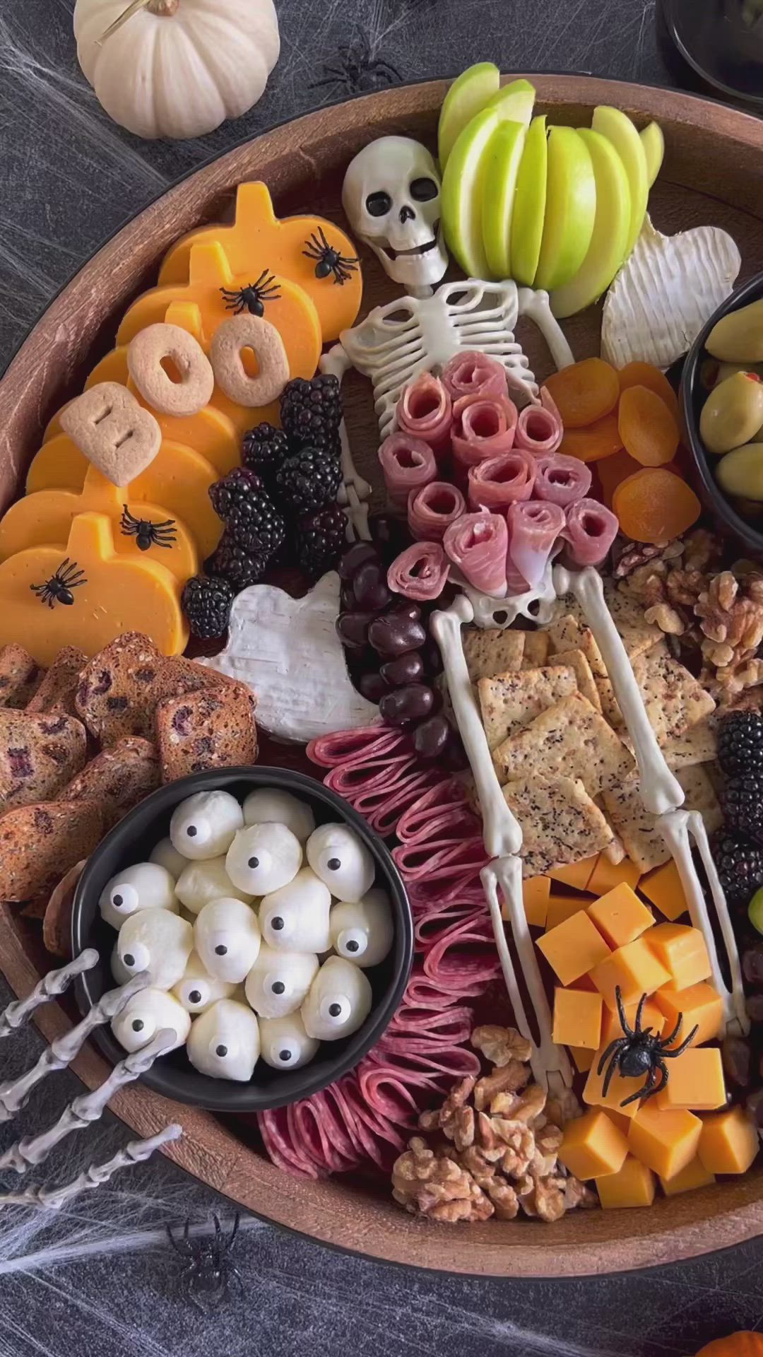 This may contain: a wooden platter filled with halloween food