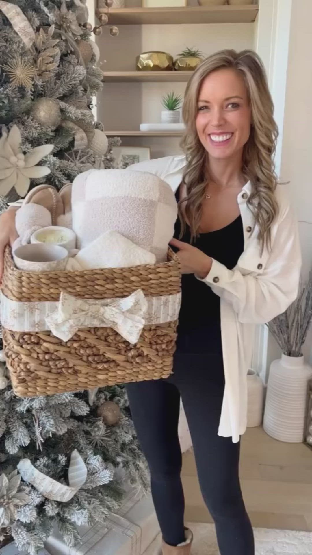 This may contain: a woman standing next to a christmas tree holding a basket