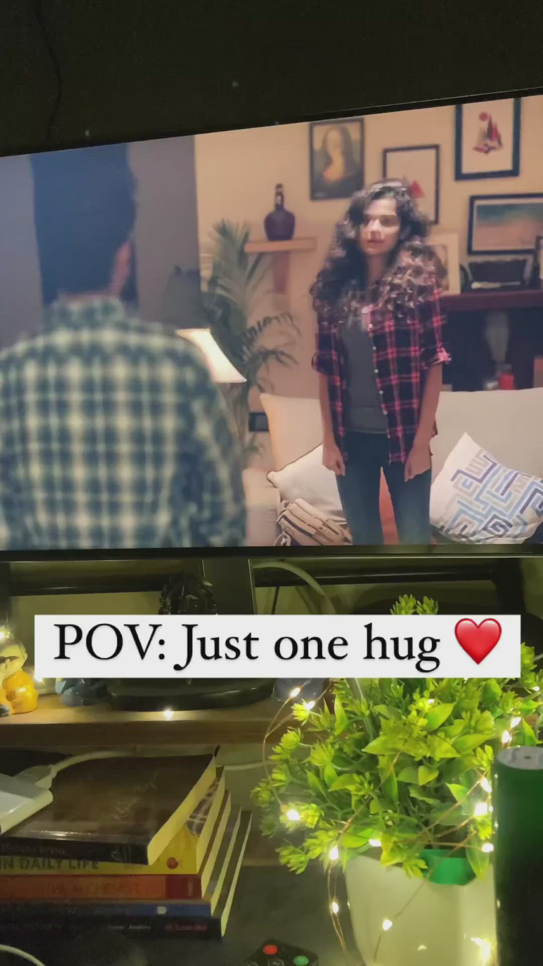 This may contain: a man and woman standing in front of a tv screen with the caption pov just one hug