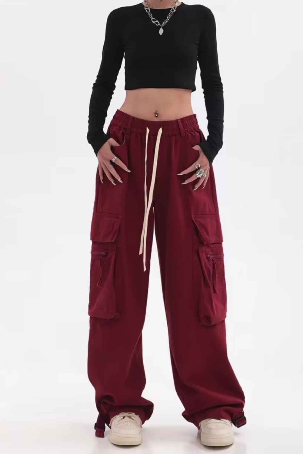 This contains: Leah cargo pants offer a vintage look with a modern twist. The wide leg design and low waist fit provide a comfortable and trendy style. The adjustable drawstring and ample pockets make these pants versatile and practical for daily wear. Perfect for casual, streetwear, or hippie-inspired outfits.