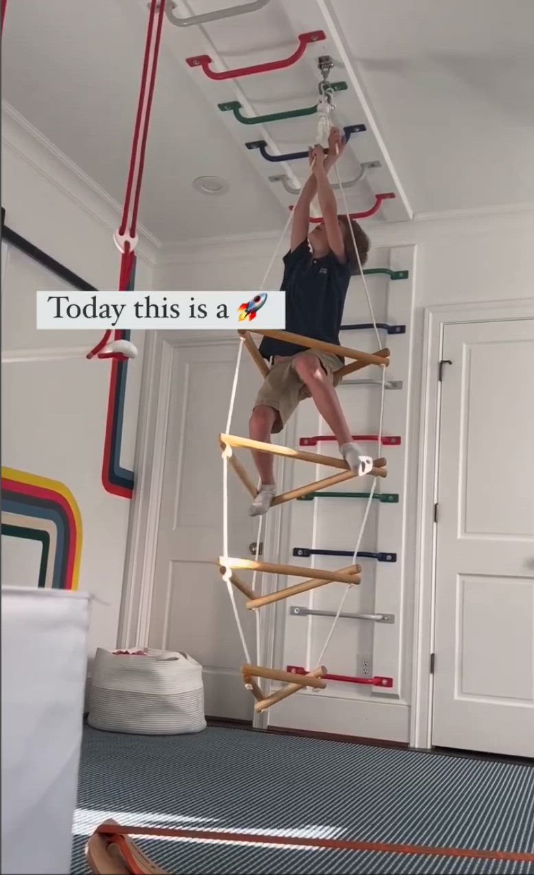 This may contain: a man is climbing up the ladder to reach the ceiling with his arms and legs