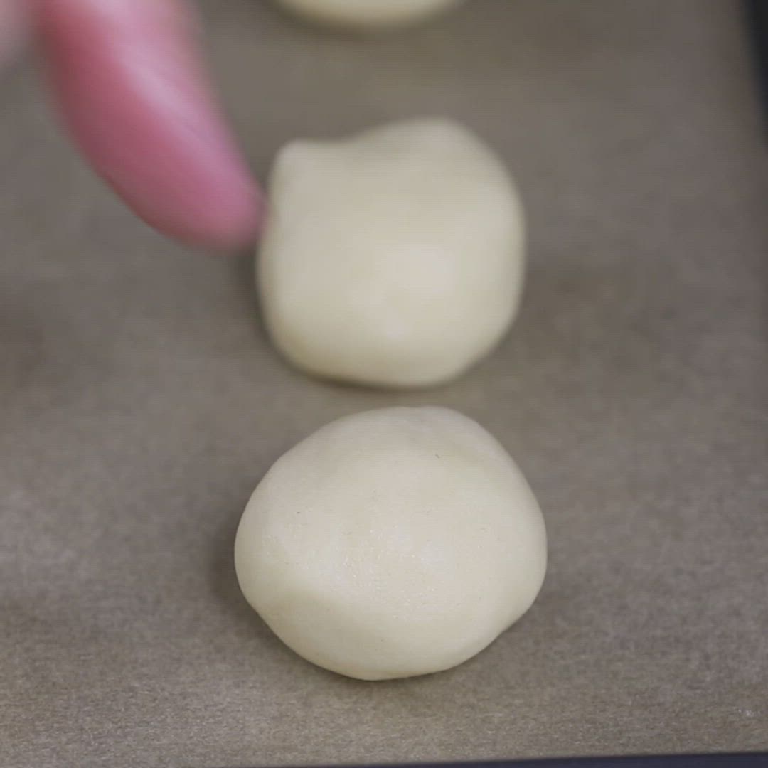 This may contain: three doughnuts are being made on a baking sheet