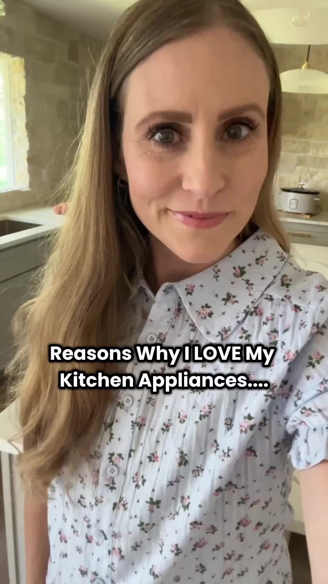 This may contain: a woman with long hair standing in a kitchen