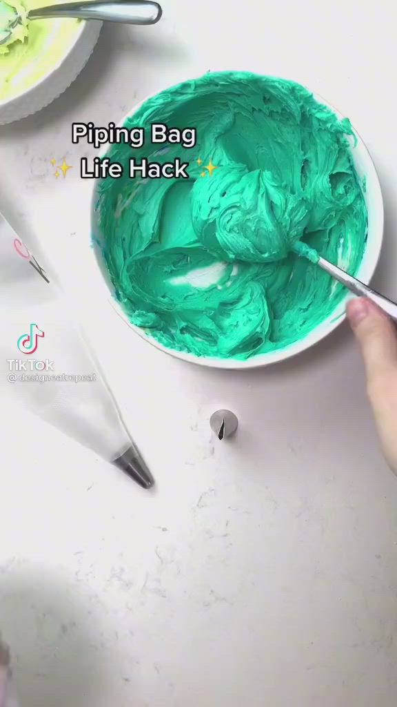 This may contain: someone is painting something green with blue and white colors on their hands while another person holds a spoon in front of them