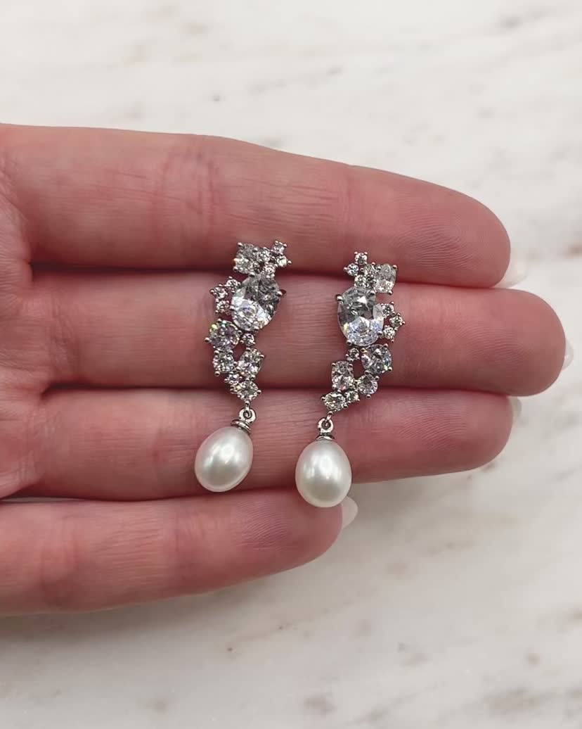 Feminine & modern, our Tate Pearl & CZ Earrings are crafted with no shortage of sparkle. Shimmering CZ stones are designed to perfectly sit along your ear with a delicate freshwater pearl drop. Cubic zirconia & freshwater pearls Beauty & dimension of freshwater pearls come from slight variations in shape & hue Measures 1.5" length Hypoallergenic, lead-free & nickel-free Style #4284