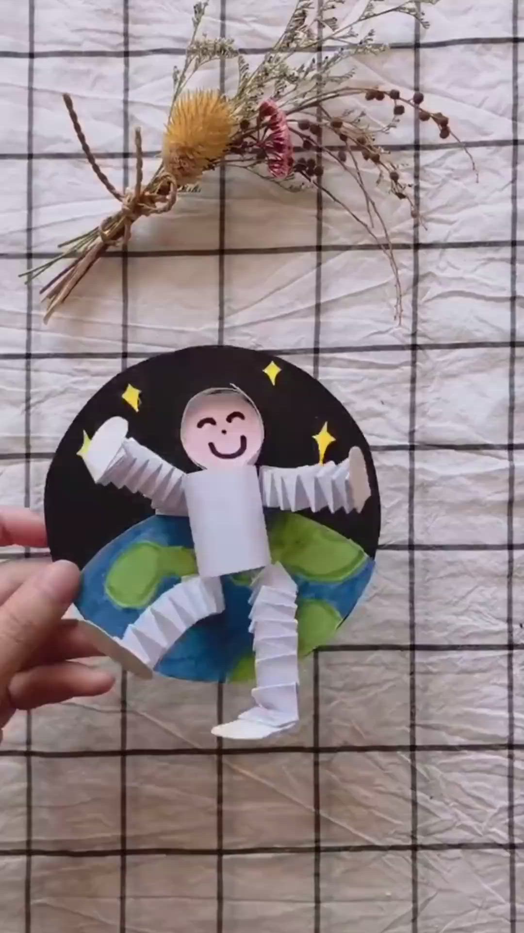 This may contain: someone is making a paper doll out of toilet paper