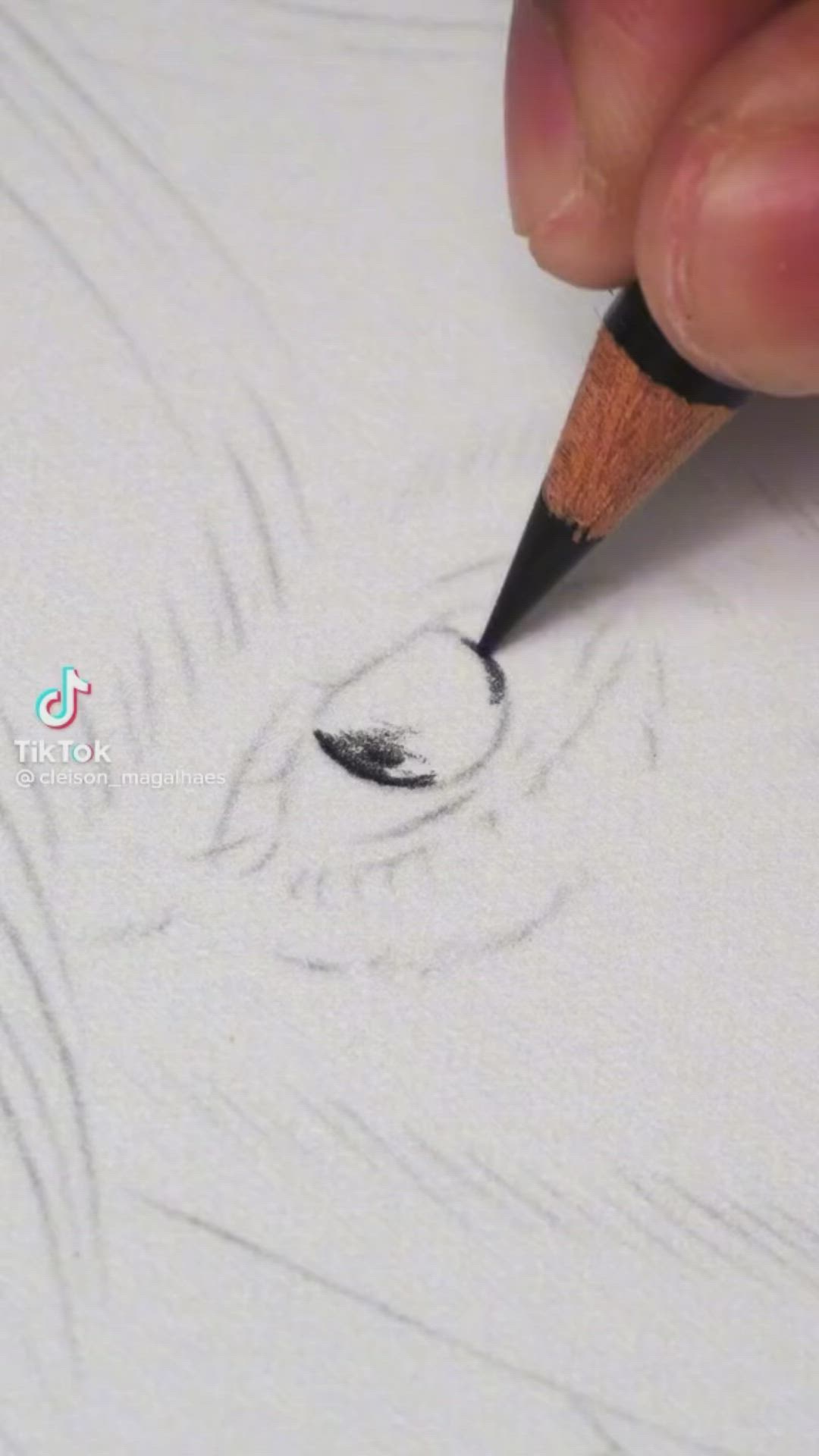 This may contain: someone is drawing an eye with a pencil