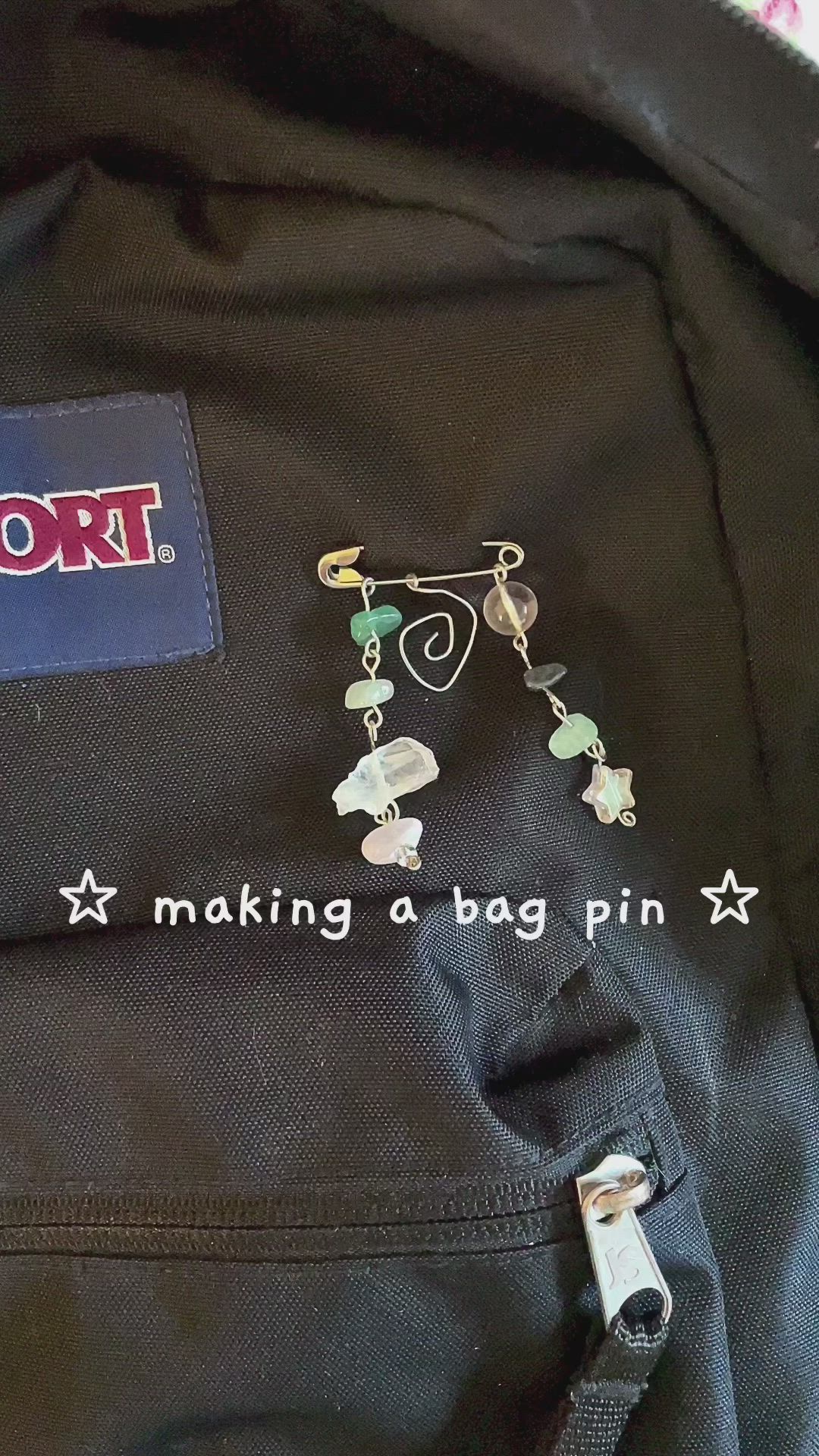 This may contain: a black backpack with some charms attached to it's back pocket and the words, making a bag pin