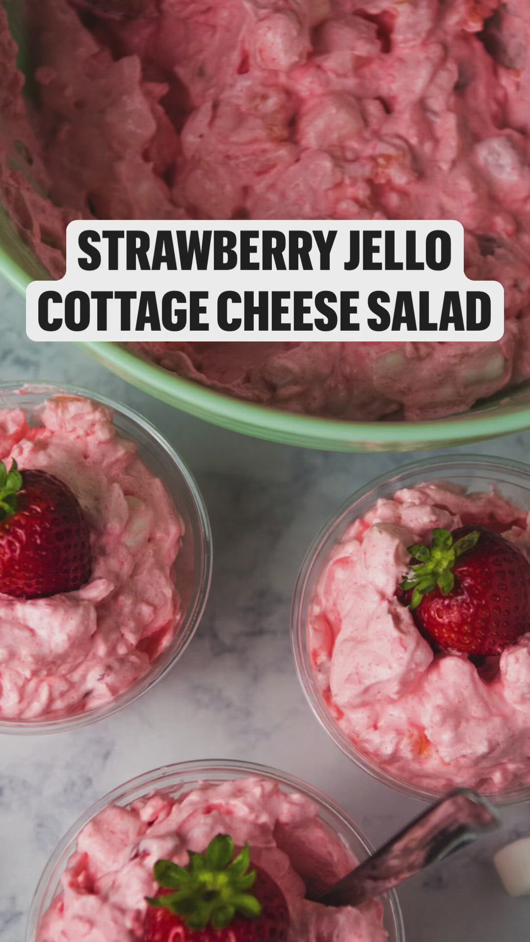 This may contain: strawberry jello cottage cheese salad in small plastic bowls with strawberries on top and text overlay that reads, strawberry jello cottage cheese salad