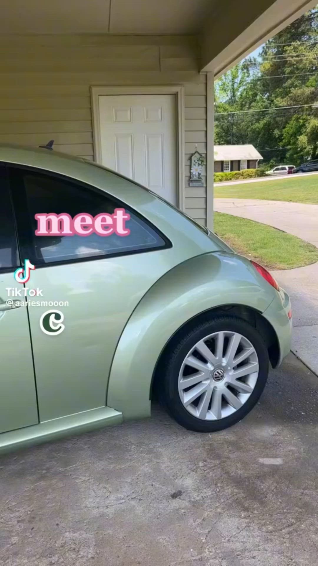 This may contain: a green car parked in front of a garage with the word meet written on it