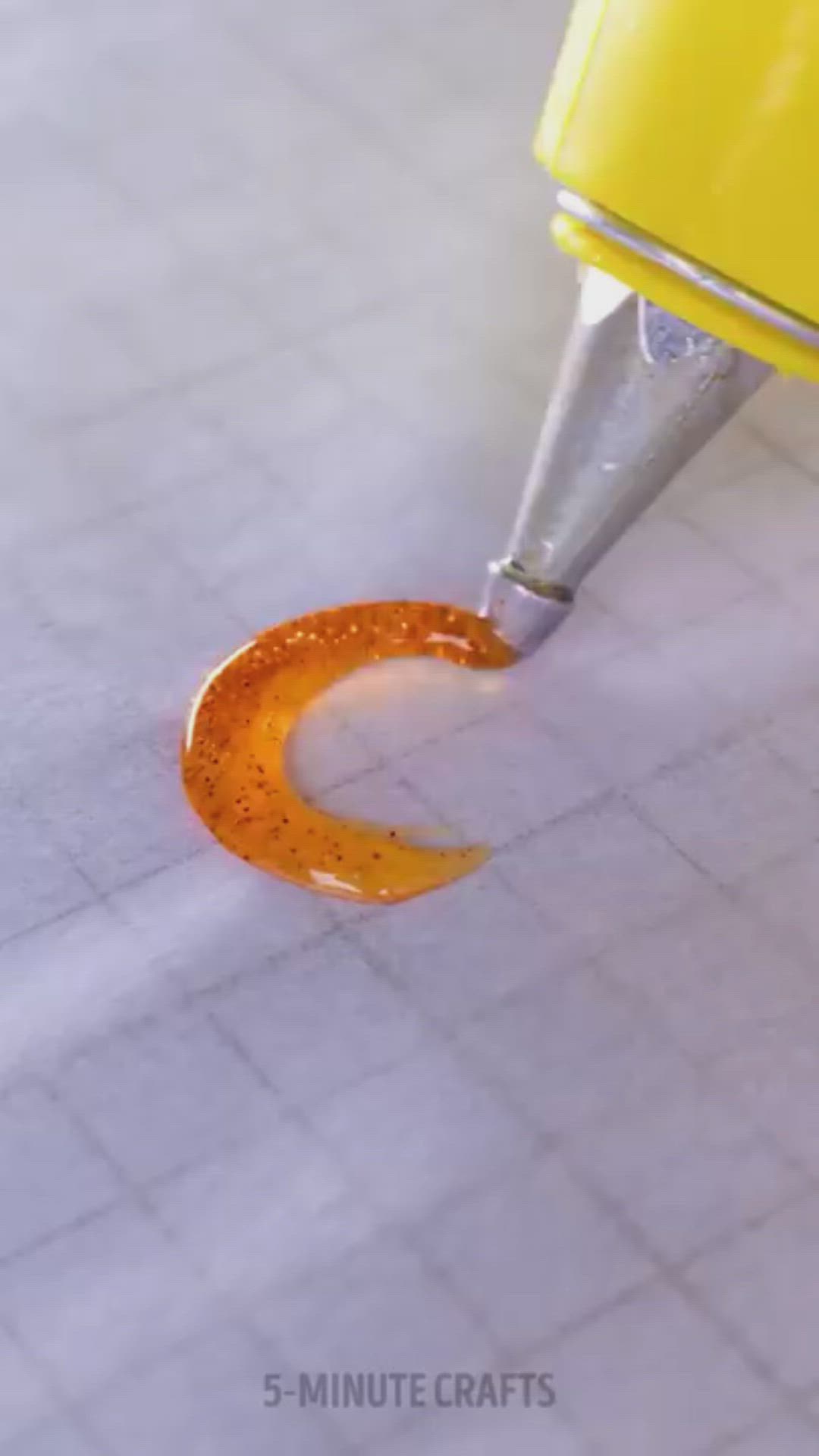 This may contain: a close up of a person using a machine to make something orange