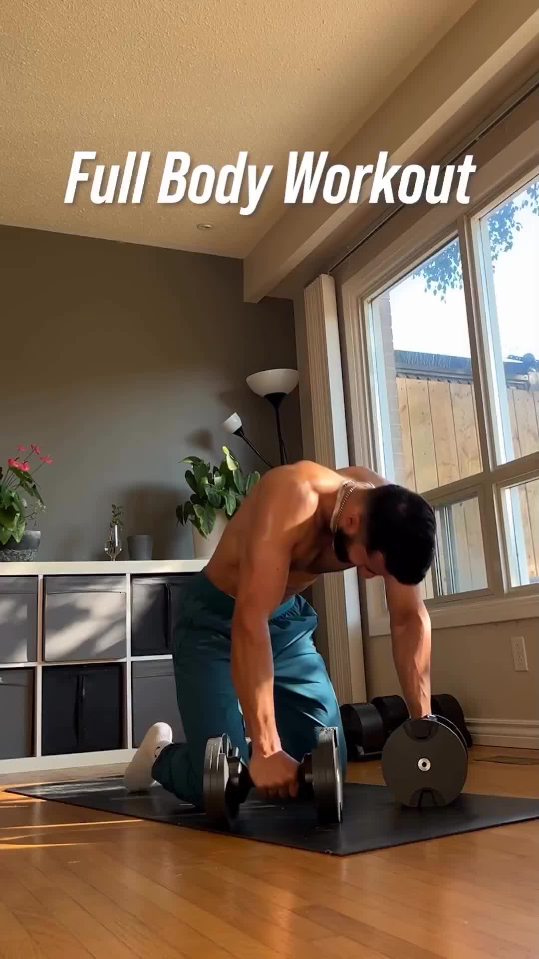 This may contain: a man is doing exercises with dumbbells on the floor in front of a window