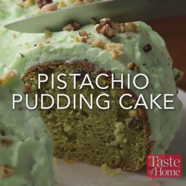 This may contain: a cake with green frosting and walnuts on top is cut in half to show the inside