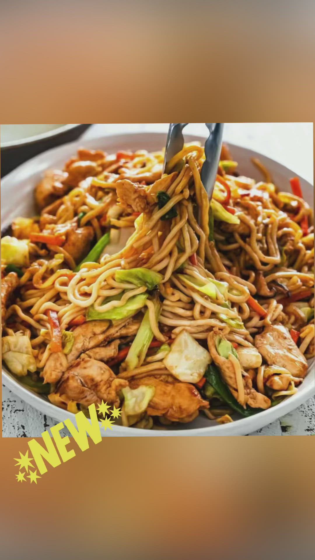 This may contain: a bowl filled with noodles and vegetables on top of a table