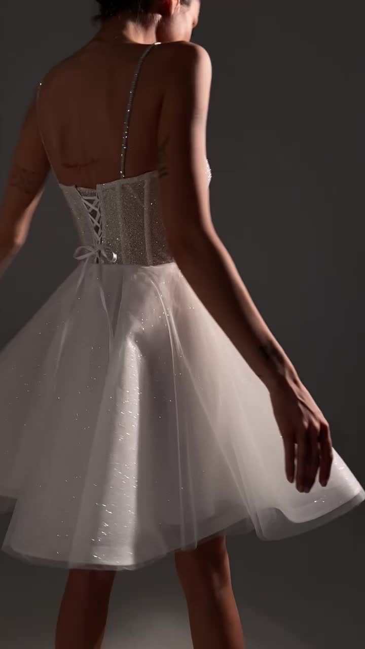 This contains: Semi sweetheart neckline spaghetti straps shimmery glitter tulle babydoll chic city hall wedding dress