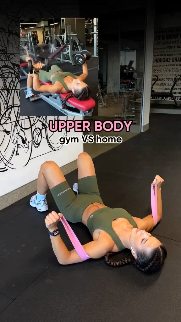 This may contain: a woman laying on top of a gym floor holding a pink belt in her hand