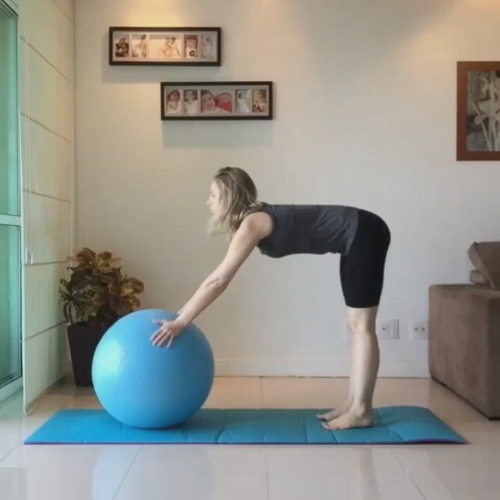 This may contain: a woman is doing exercises on an exercise ball