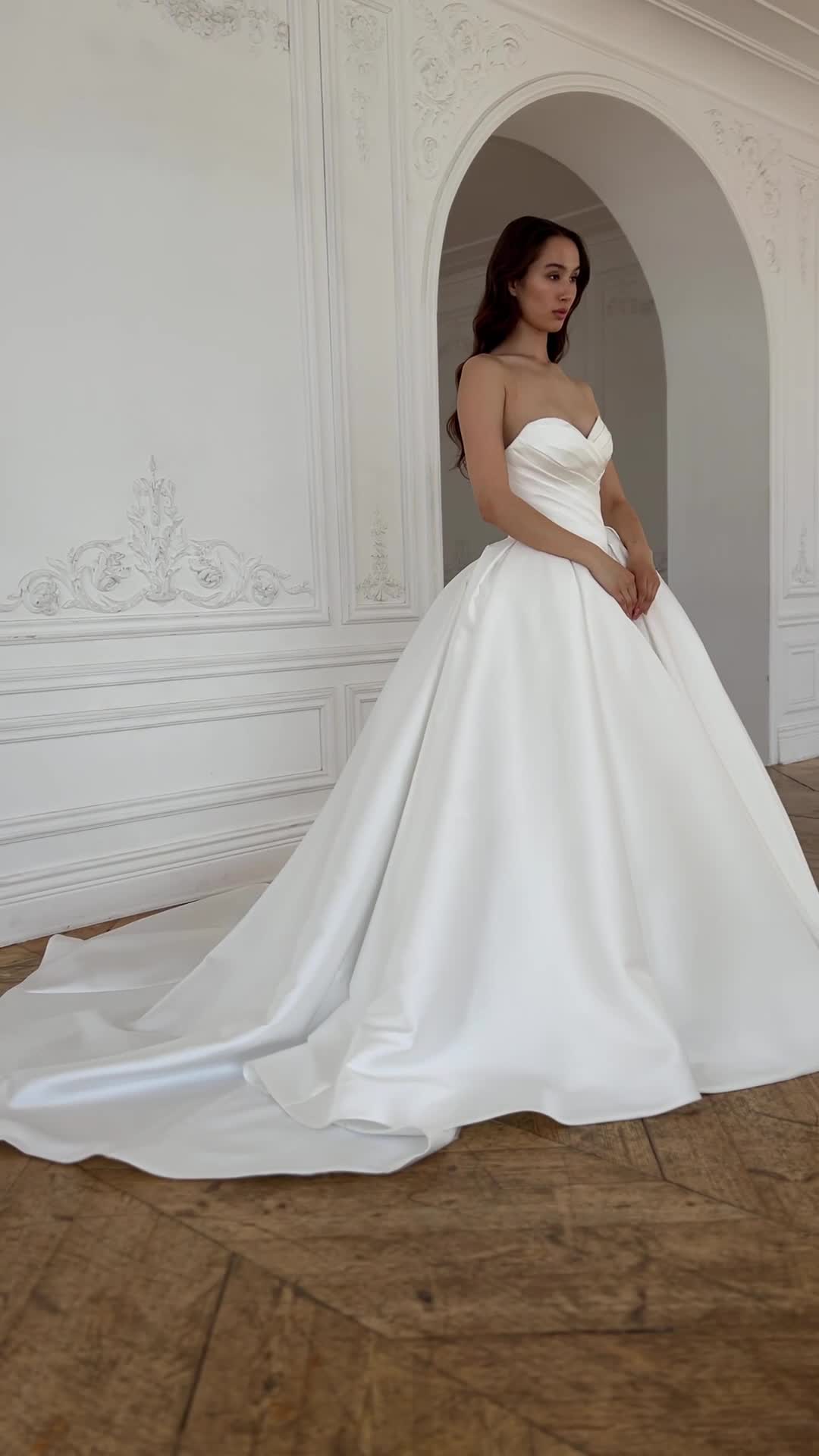 This contains: Off-the-shoulder sweetheart neckline draped corset puff skirt satin classy elegant old money wedding dress