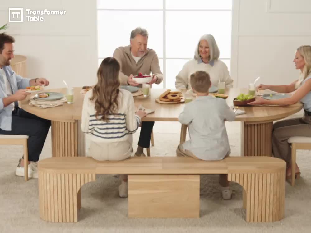 This may contain: a group of people sitting around a wooden table eating food and drinking water from cups