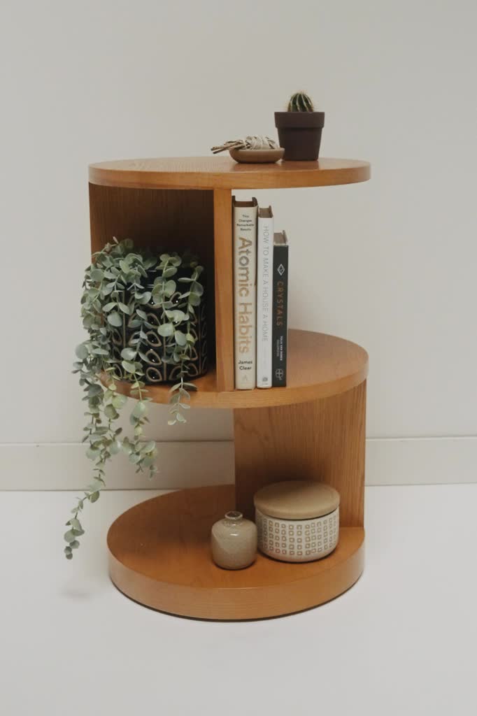 A three tiered cylindrical side table with a fun cut out design will store your favorite treasures in the most creative way. Add a plant for a touch of greenery and candles on top for a warm and calming moment. Rounded design Cut out shelf space for maximum storage Variance in wood grain Fully assembled