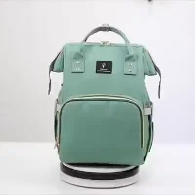 This may contain: a green backpack with matching items on the front and back sides, sitting upright against a white background