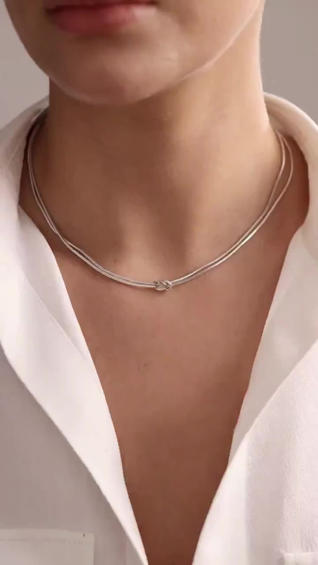 The Dainty Silver Knot Necklace is the perfect blend of elegance and symbolism. Featuring a delicately crafted knot pendant, this necklace represents the unbreakable bond between loved ones or the strength within yourself. Its minimalist design adds a touch of subtle sophistication, making it an ideal accessory for both casual and formal outfits.