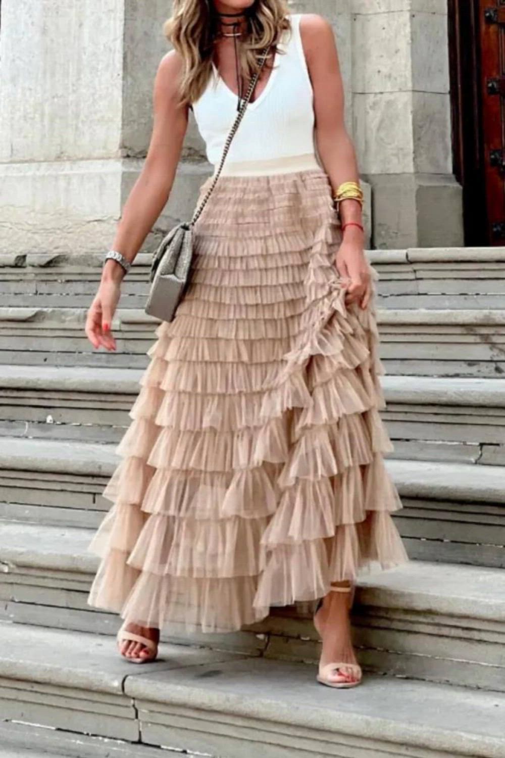 This elegant party skirt features a captivating layered ruffle design in a solid color. Its exquisite craftsmanship and sophisticated style make it a perfect choice for any special occasion. Elevate your fashion statement with this graceful and enchanting piece.