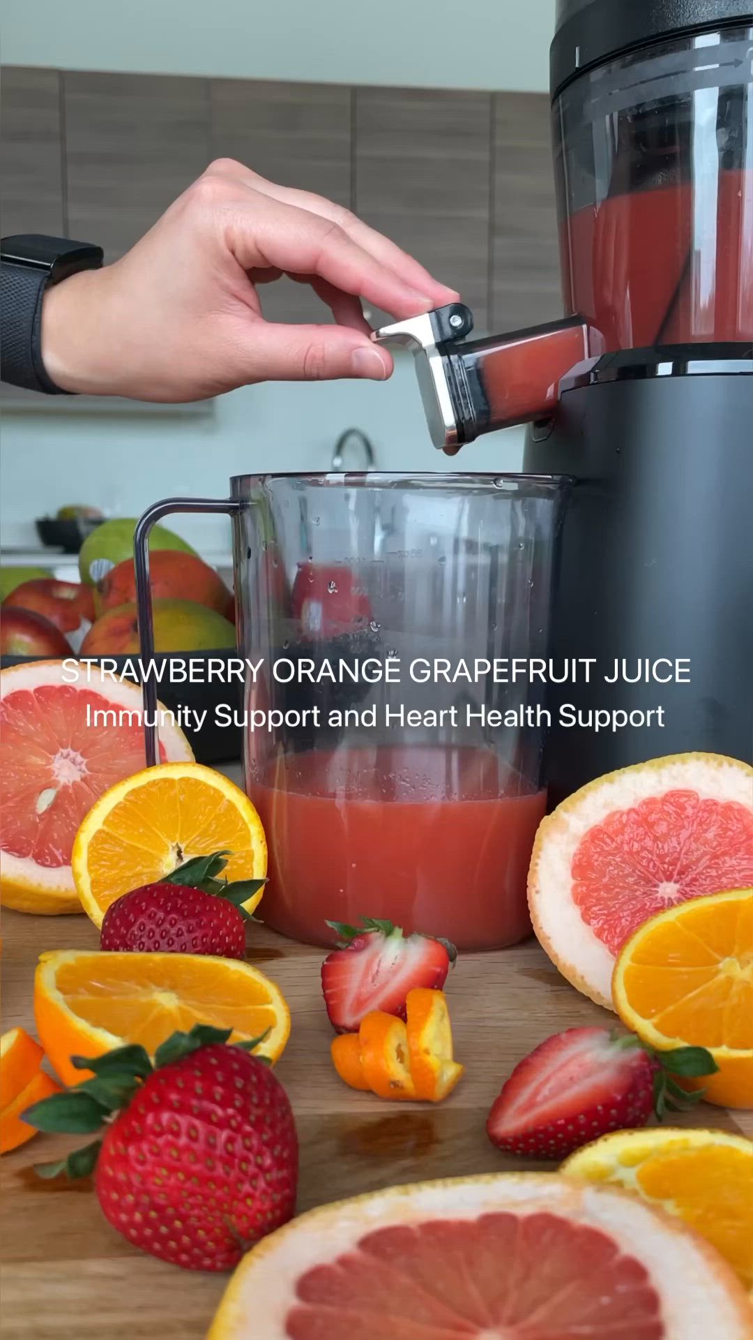 This may contain: someone using a juicer to make oranges and strawberries in the blender