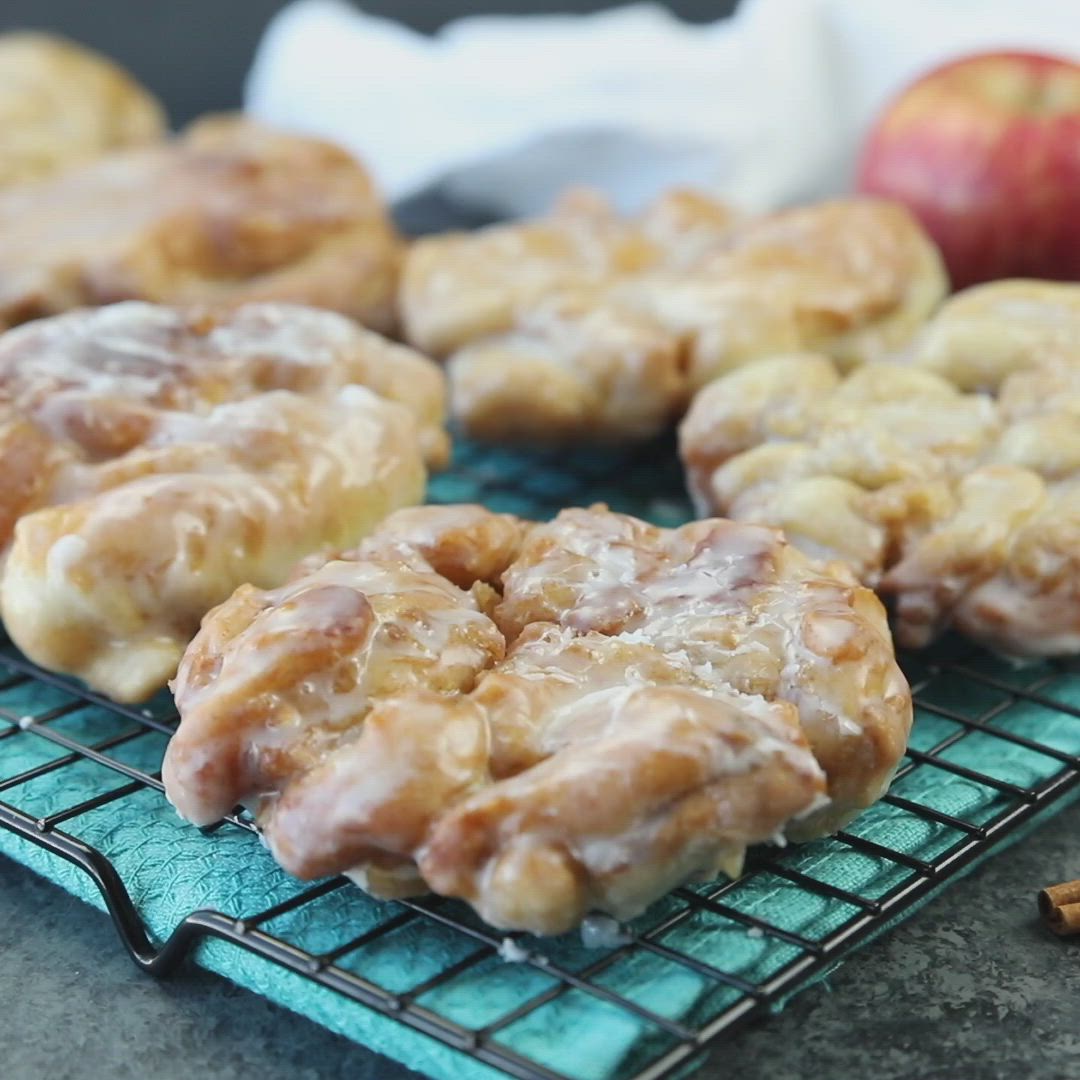 This may contain: apples and cinnamon donuts on cooling racks with the words easy apple fritters