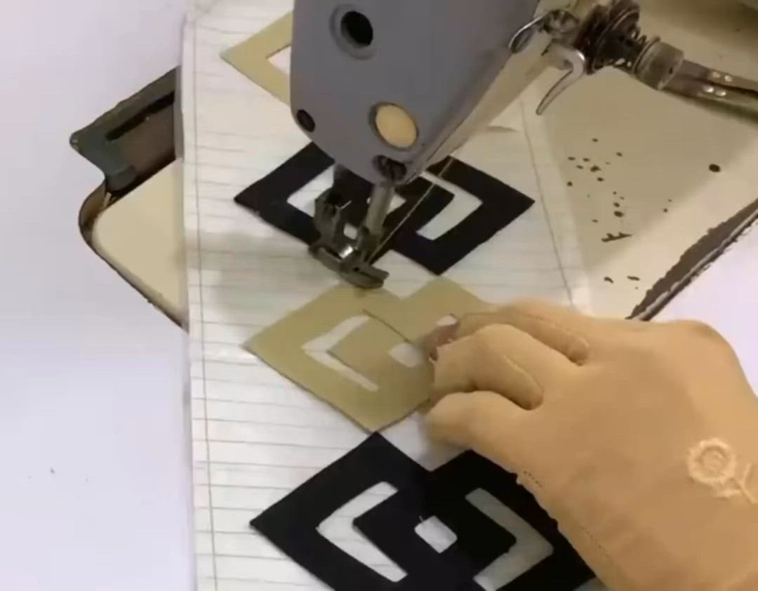 This may contain: someone is using a sewing machine to sew letters